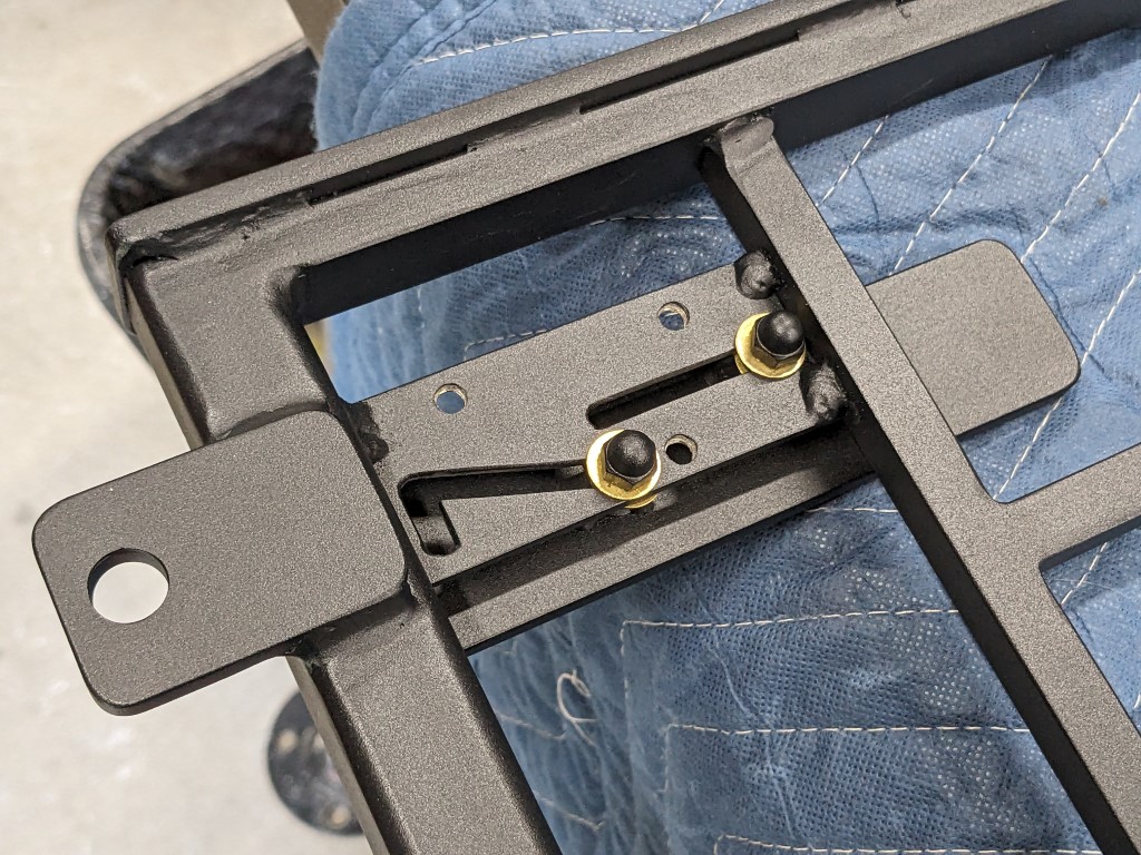 Custom steel gate hinge and floor plate base hardware detail, welded and coated