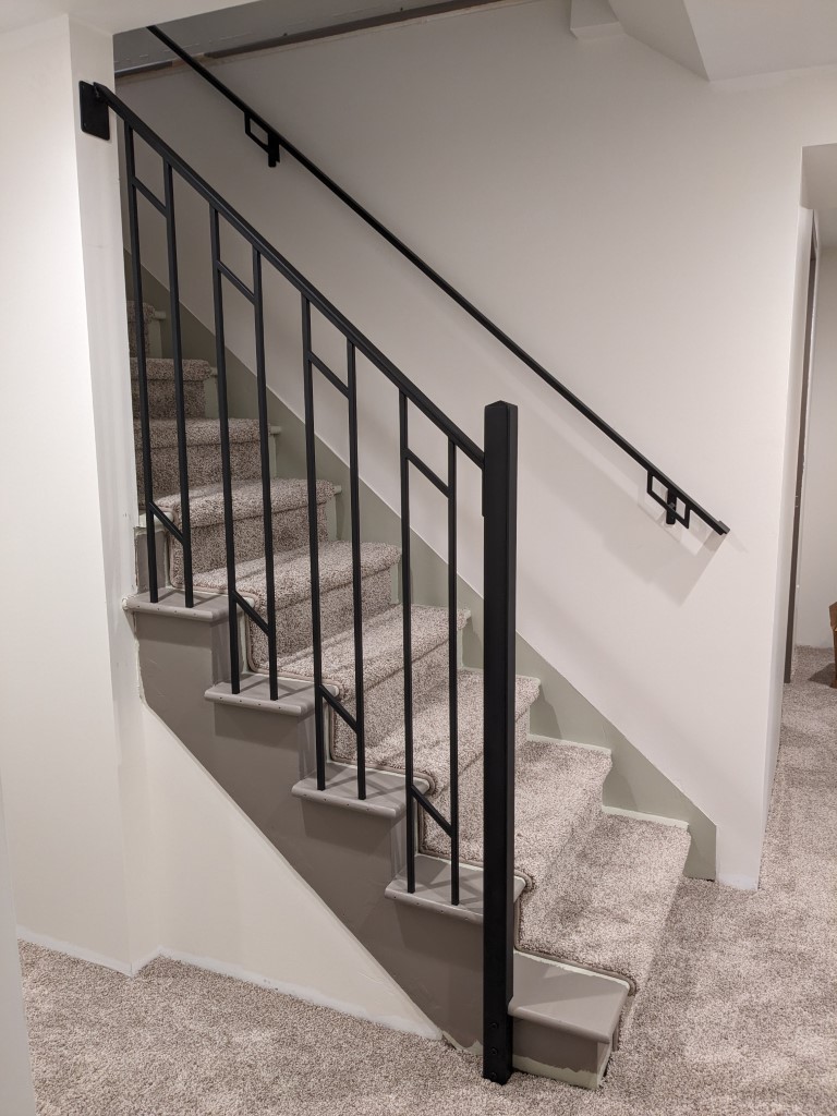 Custom black steel stair railing and handrail system installed in Minneapolis home