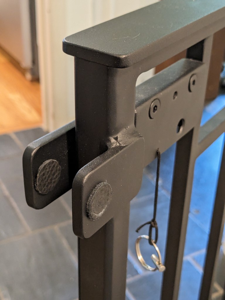 Close-up of custom gate latch and lift mechanism, fabricated steel hardware