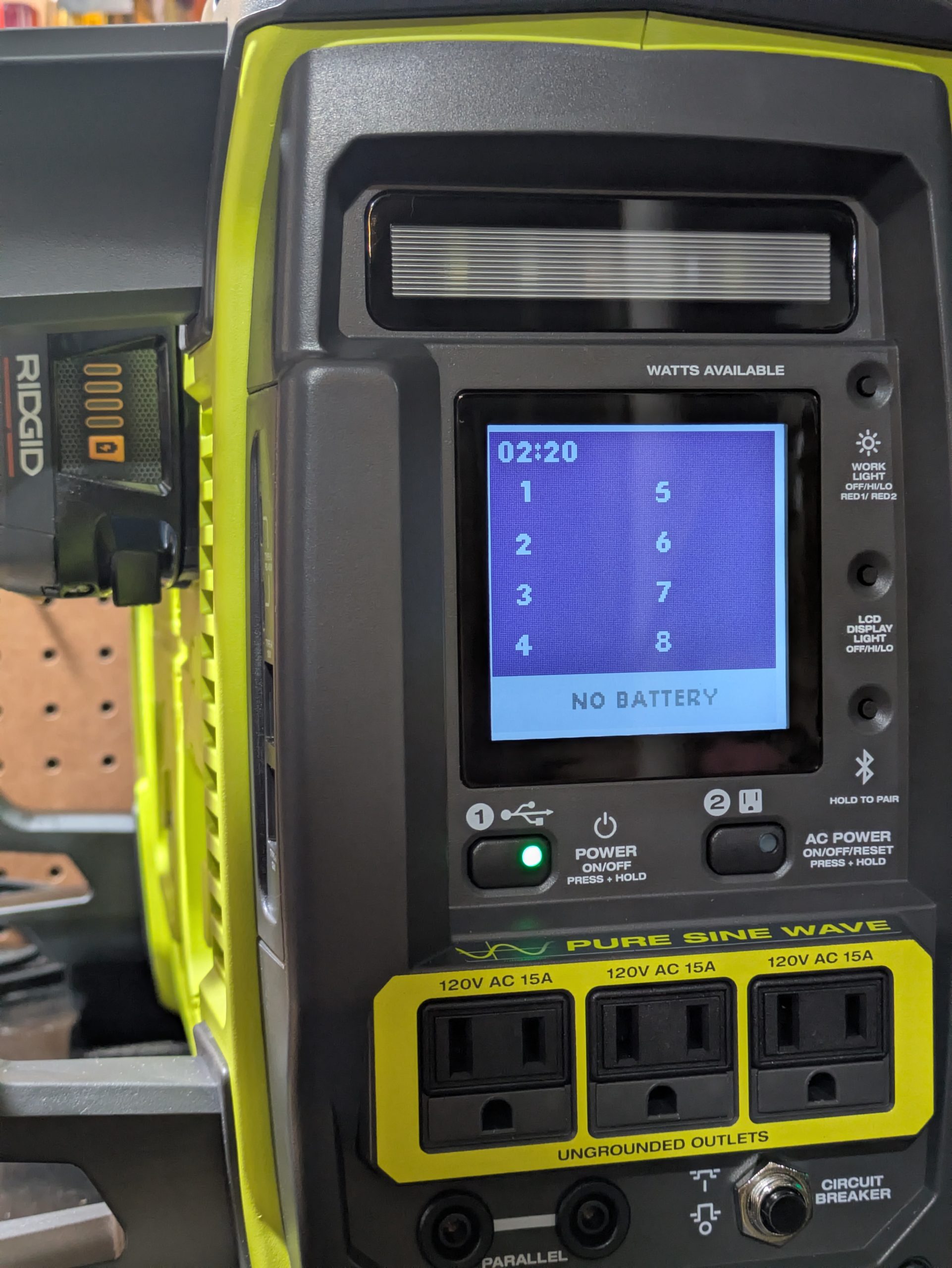 Ryobi power station display reading NO BATTERY while a Ridgid 18V pack sits seated in bay one through a printed adapter