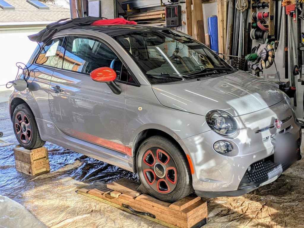 Fiat 500e in the shop for undercoating