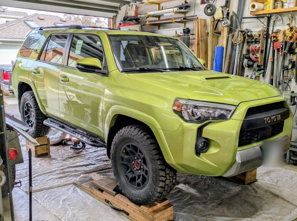 Lime green Toyota 4Runner TRD Pro in the shop for undercoating
