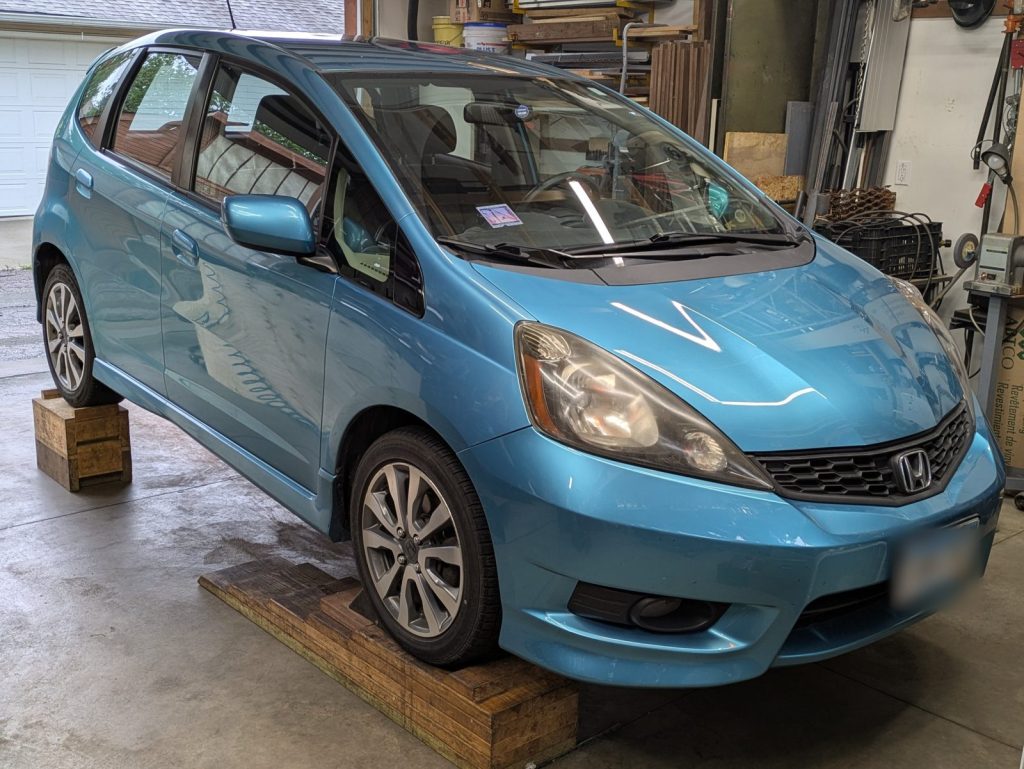 Honda Fit in the shop for undercoating